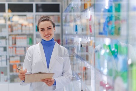 Photo for Portrait of young pharmacist in pharmacy store. - Royalty Free Image