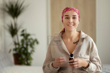 Foto de Young woman with cancer taking the pills, cancer awareness concept. - Imagen libre de derechos