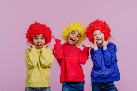 Photo for Happy children playing on clown, studio shoot. - Royalty Free Image