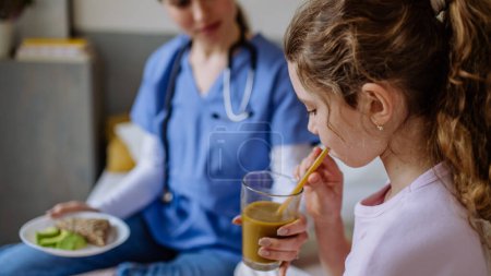 Close up of little girl having healthy breakfast in a hospital room.