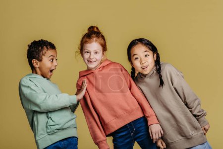 Photo for Portrait of three excited children, studio shoot. Concept of diversity in a friendship. - Royalty Free Image
