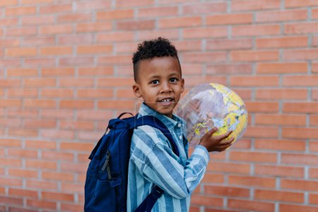Photo for Multiracial boy playing outdoor with a beach ball. - Royalty Free Image