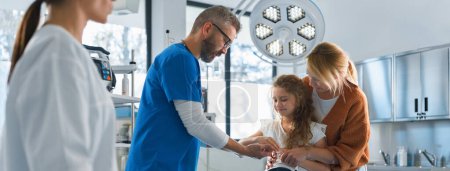 Photo for Little girl with mother in surgery examination. - Royalty Free Image
