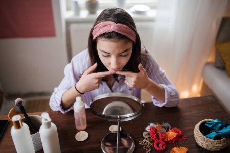 Photo for Teenage girl doing her skin care routine in the room. - Royalty Free Image