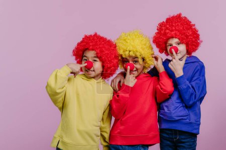 Photo for Happy children playing on clown, studio shoot. - Royalty Free Image