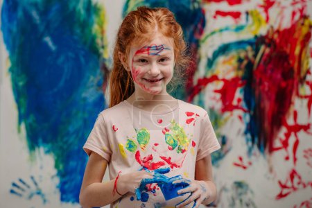 Photo for Portrait of happy kid with finger colours and painted t-shirts. - Royalty Free Image