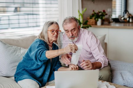 Photo for Senior couple checking their bills, concept of finance. - Royalty Free Image