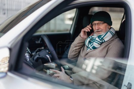 Photo for Senior mansitting in the car and calling. - Royalty Free Image