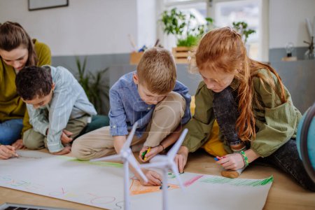 Photo for Children drawing a project to environmental lesson in school. - Royalty Free Image