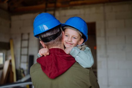 Photo for Father and his little son cuddling in their unfinished home. - Royalty Free Image