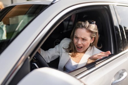 Photo for Upset woman driving her car in city. - Royalty Free Image