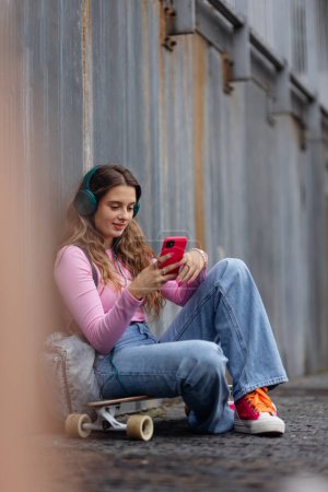 Photo for Portrait of generation z girl student sitting outdoors in the city. Student spending free time online and alone. Concept of gen Z as loneliest generation. - Royalty Free Image