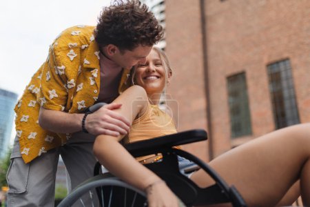 Photo for Beautiful gen Z girl in a wheelchair with her boyfriend. Inclusion, equality, and diversity among Generation Z. - Royalty Free Image