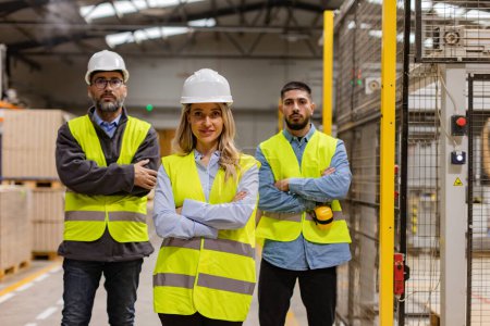 Photo for Portrait of team of warehouse employees standing in warehouse. Team of workers and female manger in modern industrial factory, manufactrury. Concept of team management. - Royalty Free Image