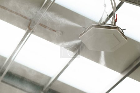 Photo for Industrial dust control system in the modern manufacturing factory. Dust suppression with water mist, creating fine water mist, moistening dust particles. - Royalty Free Image