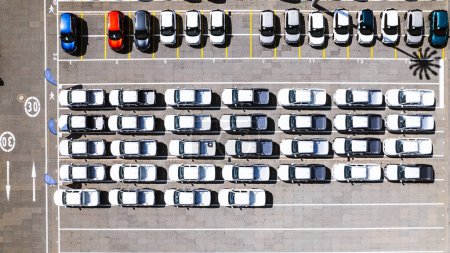 Photo for Aerial view of parking lot at a car manufacturing facility with newly produced vehicles parked in rows. - Royalty Free Image