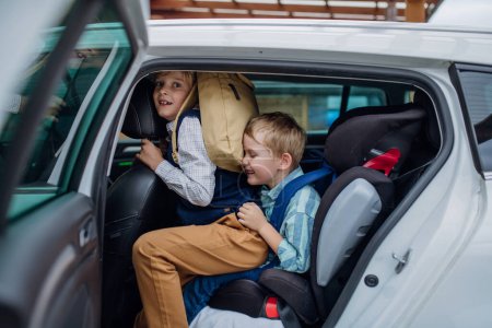 Photo for Children getting into the car, father is taking them to school and kindergarten before going to work. - Royalty Free Image