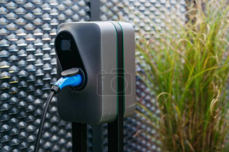 Photo for Close up electric car charging station in front of the office building. Charging at work, workplace. - Royalty Free Image