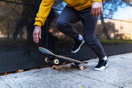 Photo for Close up on legs and skateboard of man skating in the city. Stylish skateboarder training in skate park. Concept of skateboarding as sport and lifestyle. - Royalty Free Image