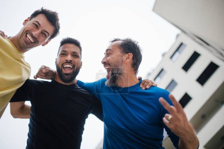Photo for Best friends playing sport outdoors, having fun, competing. Playing basketball at local court, enjoying exercise together. Concept of male friendship, bromance. - Royalty Free Image