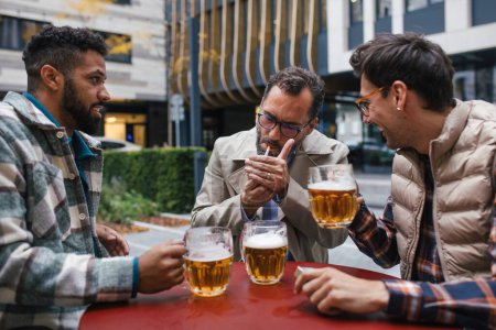 Photo for Best friends togehter, drinking beer in bar in the city and talking, having fun and laugh. Concept of male friendship, bromance. - Royalty Free Image