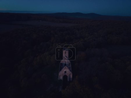 Photo for Aerial view of old ruins of historical castle in the middle of forest. Drone view of natural landscape with broken fortress during sunset. - Royalty Free Image