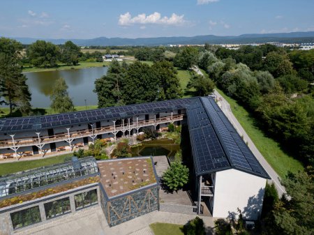 Aerial view of a solar panels on rooftop of hotel complex, resort. Solar energy as renewable energy source in business.