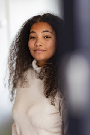 Photo for Portrait of beautiful curvy woman in turtleneck, with beautiful curly hair, looking at camera. - Royalty Free Image