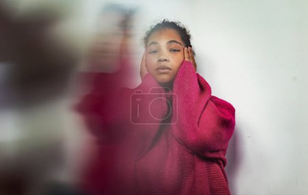 Photo for Portrait of sad, anxious womman holding her head in hands, looking at camera. Concept of womens mental health. - Royalty Free Image