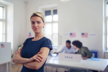 Photo for Portrait of female voter filling election ballot paper. US citizen voting in a polling place on election day, usa elections. - Royalty Free Image