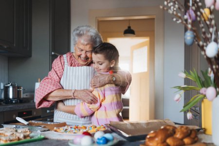 Photo for Grandmother with granddaughter preparing traditional easter meals, baking cakes and sweets. Passing down family recipes, custom and stories. Concept of family easter holidays. - Royalty Free Image