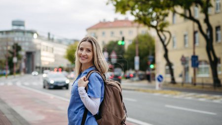 Photo for Nurse, doctor in uniform walking across city, going to work, hospital, clinic. Work-life balance of healthcare worker. - Royalty Free Image