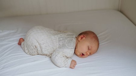Photo for Portrait of cute little baby sleeping in bed, lying on on belly, closed eyes. - Royalty Free Image