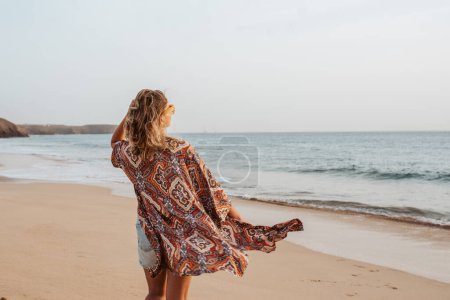Photo for Rear view of a beautiful slim woman standing on sand beach. Full body shot of barefoot woman looking at sea. Concept of beach summer vacation. - Royalty Free Image