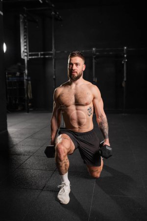 Man performing dumbbell lunge, holding dumbells in both hands. Strength exercise. Routine workout for physical and mental health.
