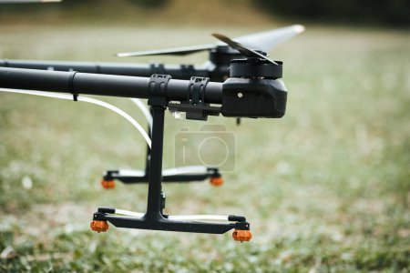 Close up of spray nozzles on agricultural drone. Dron spraying crops, distribute pesticides, herbicides and fertilizers efficiently and precisely. Technologies in modern farming.