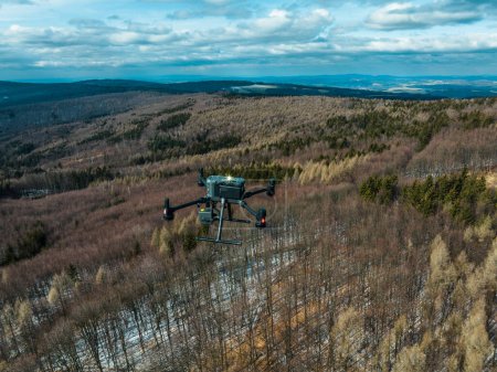 Aerial view of a drone moderning over forest, monitoring and analyzing in the forestry management. Dron mapping forest after natural disaster assessing damage.