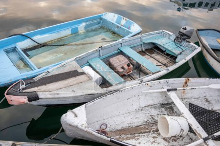 Sailing Against Time: Old Boats Fighting to Stay Afloat. Embark on a voyage through time with this captivating photo explores the captivating world of maritime heritage, weathered by years of service, battle against the relentless forces of decay. 