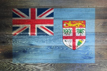 Foto de Una bandera de Fiyi en rústica superficie de madera vieja fondo unión jack escudo de armas - Imagen libre de derechos