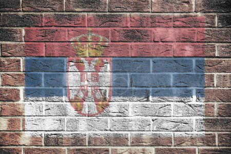 Un drapeau de Serbie sur un vieux fond de mur de briques