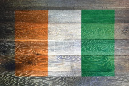 Ivory Coast Cote divoire flag on rustic old wood surface background