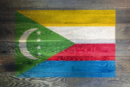 Bandera de las Comoras sobre fondo rústico de madera vieja