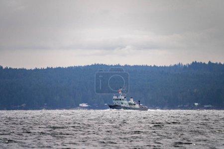 Photo for The Canadian forces torpedo recovery vessel Stikine sails northward in the Georgia Strait, near Nanaimo, British Columbia, Canada. - Royalty Free Image