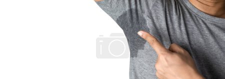Sweaty man with stain wet armpit on t-shirt against gray free space