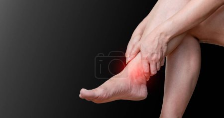 Photo for Ankle osteoarthritis Joint pain, arthritis and ligaments on a black backgroun - Royalty Free Image