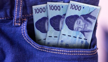 Photo for Bunch of South Korea 1000 Won banknotes in a jeans pocket a concept of spending - Royalty Free Image