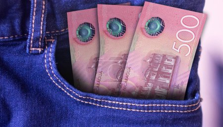 Bunch of 500 Nicaragua Cordobas banknotes in a jeans pocket a concept of spending