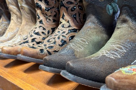Photo for Closeup of handmade leather cowboy boots in a market in Texas, western vintage collection. - Royalty Free Image