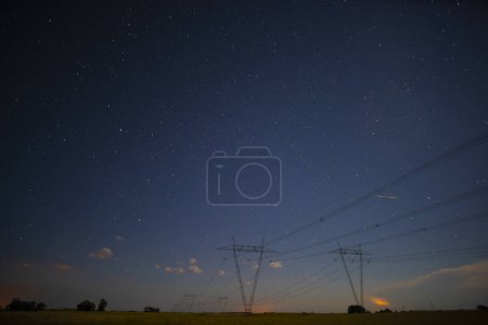 Photo for High voltage power line in a nocturnal landscape, La Pampa, Patagonia, Argentina. - Royalty Free Image