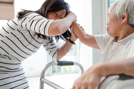 Foto de Angry asian senior grandma with bad temper,Dissatisfied elderly woman attacking,pulling hair,fight quarrel between old people and female caregiver,concept of aggression,physical abuse,stop violence - Imagen libre de derechos